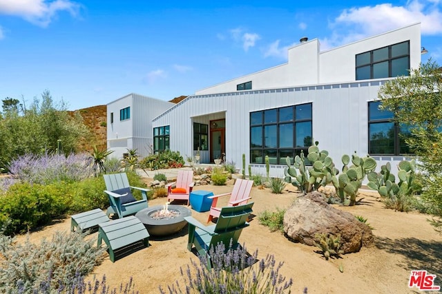 rear view of house with a fire pit