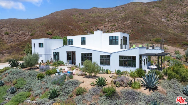 rear view of property featuring a mountain view