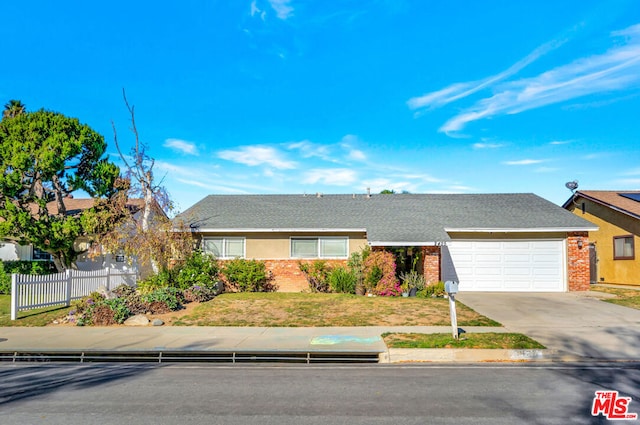 ranch-style house with a front yard and a garage