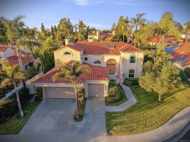 mediterranean / spanish home with a garage and a front yard