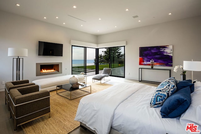 bedroom featuring access to exterior and light hardwood / wood-style floors