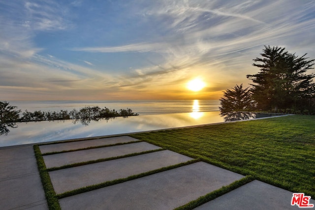 yard at dusk with a water view