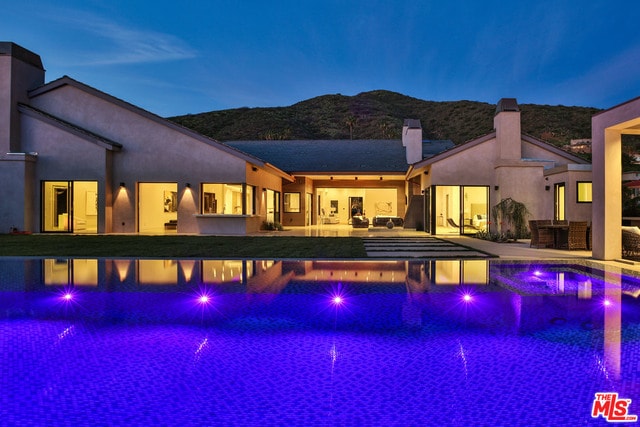 view of swimming pool featuring a patio area and a mountain view