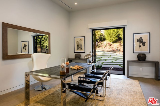 dining area featuring hardwood / wood-style floors and a healthy amount of sunlight