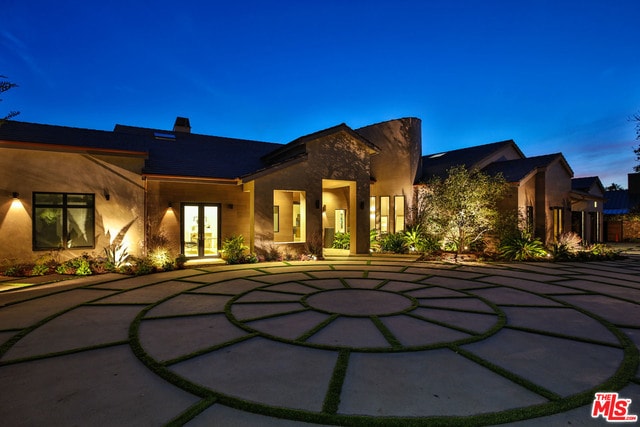 back house at dusk with french doors