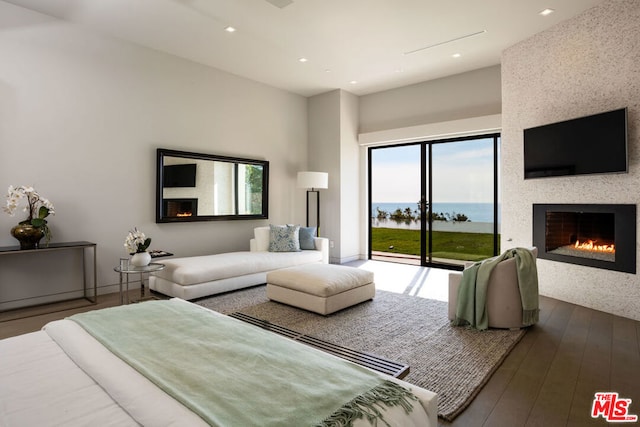 bedroom with dark hardwood / wood-style floors and access to exterior