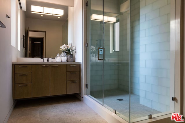 bathroom featuring vanity and a shower with shower door