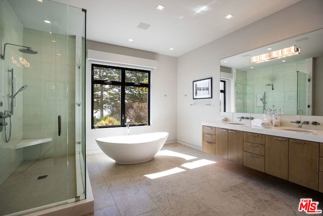 bathroom featuring vanity and independent shower and bath