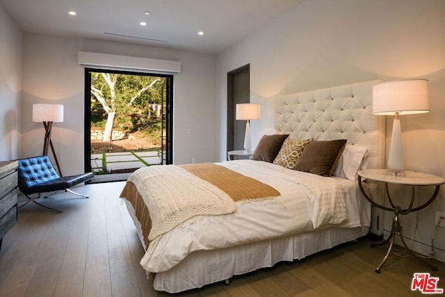 bedroom featuring access to outside and dark wood-type flooring