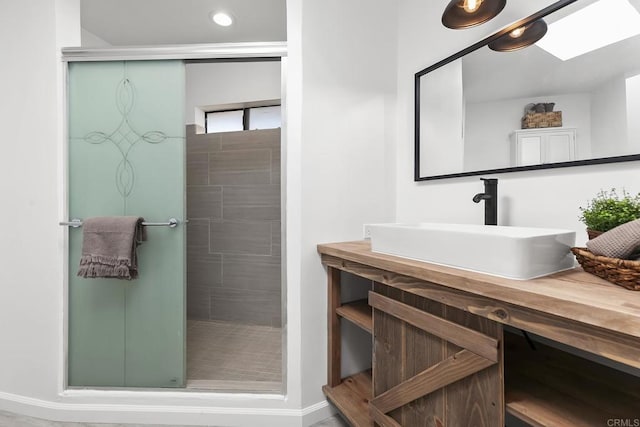 bathroom with vanity and a tile shower