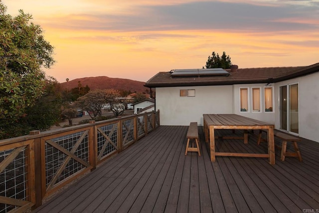 deck at dusk with a mountain view