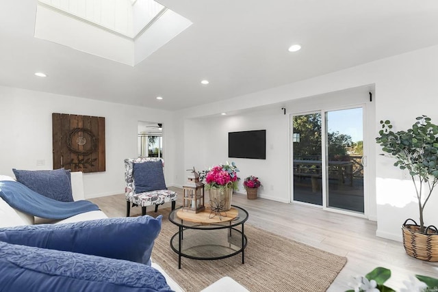 living room featuring ceiling fan and light wood-type flooring