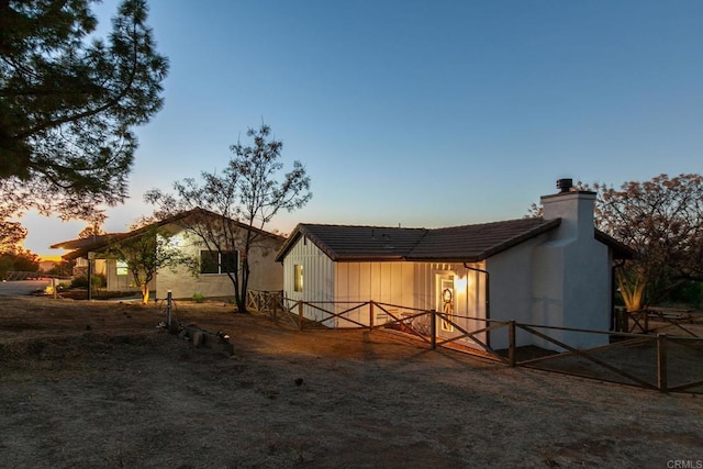 view of back house at dusk