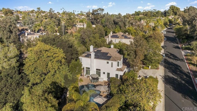 birds eye view of property with a wooded view