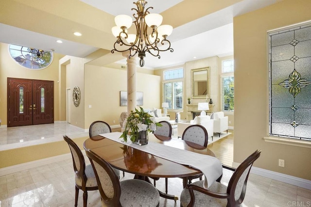 dining space with recessed lighting, baseboards, a notable chandelier, and a raised ceiling