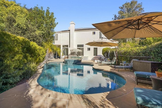 view of pool with a patio area and a pool with connected hot tub