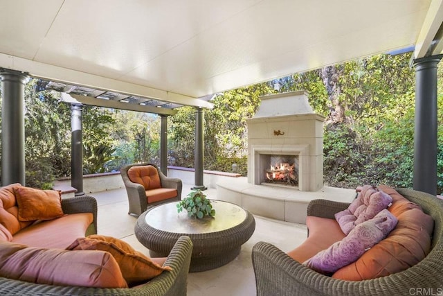 sunroom / solarium featuring a tiled fireplace and a healthy amount of sunlight