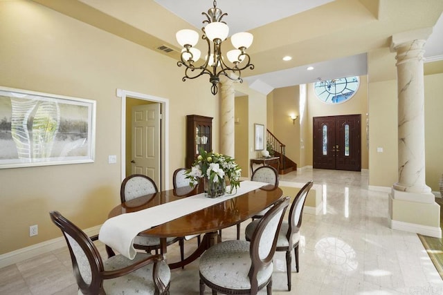 dining room with visible vents, a tray ceiling, baseboards, and decorative columns