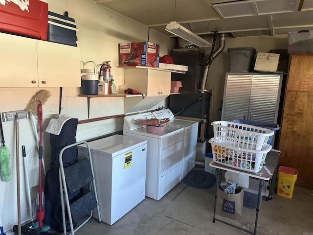 clothes washing area with cabinets and independent washer and dryer