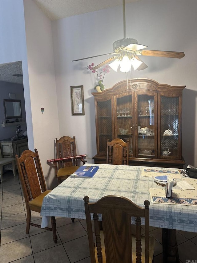 tiled dining space featuring ceiling fan