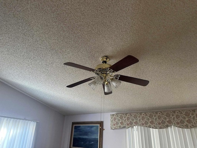 room details featuring ceiling fan and a textured ceiling