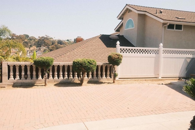 124 Palawan Way, San Diego, CA 92114 - view of side of home featuring stucco siding and a chimney
