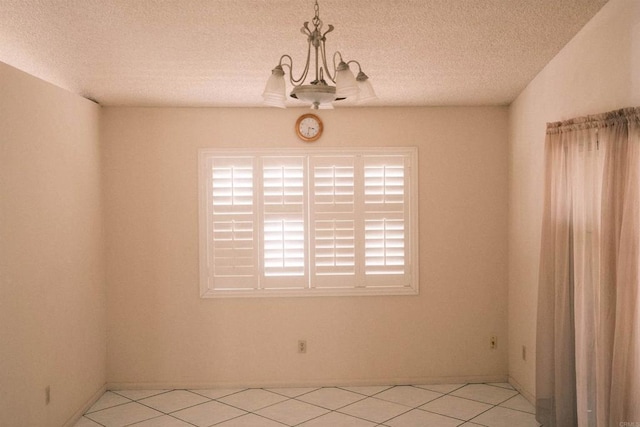 124 Palawan Way, San Diego, CA 92114 - spare room featuring light tile patterned floors, a textured ceiling, and a chandelier
