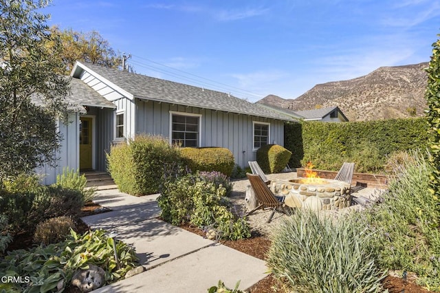 exterior space with an outdoor fire pit, a patio, and a mountain view