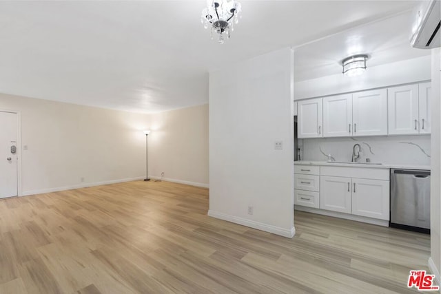 interior space featuring light wood-type flooring, an AC wall unit, and sink