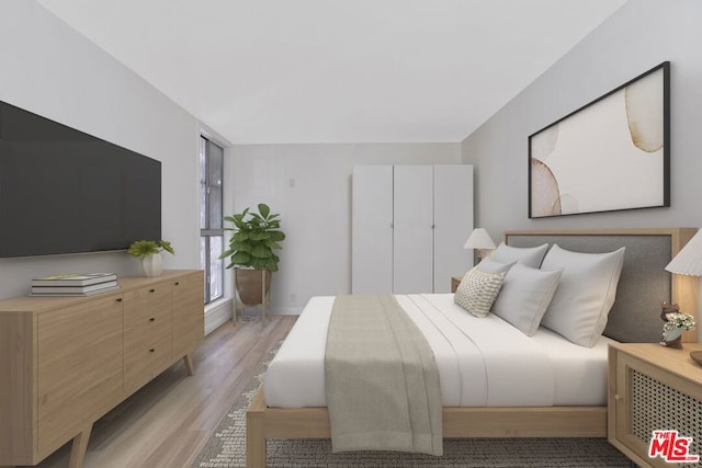 bedroom with light hardwood / wood-style flooring