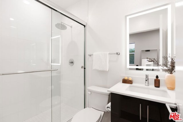 bathroom featuring vanity, toilet, and walk in shower