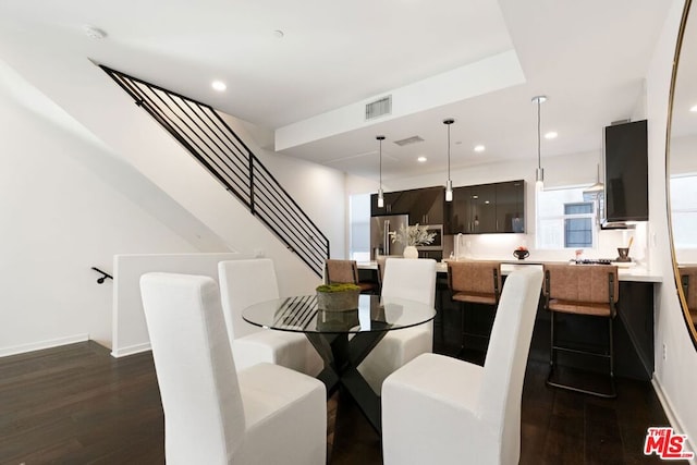 dining area featuring dark wood-type flooring