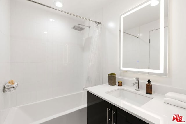 bathroom featuring vanity and shower / bathtub combination with curtain