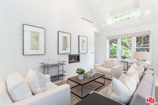 living room with high vaulted ceiling