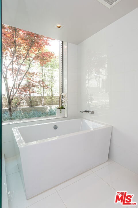 bathroom featuring tile patterned flooring and a bathtub