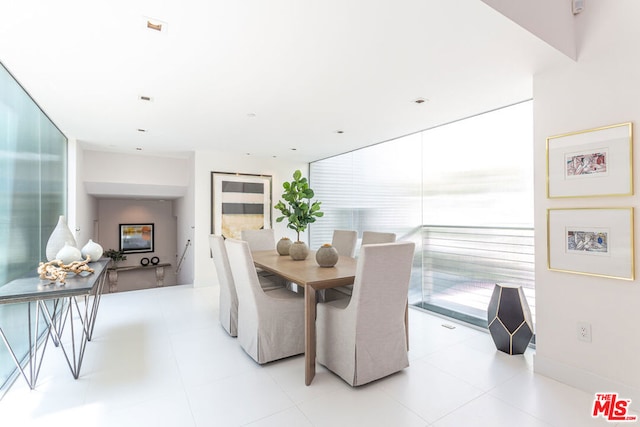 dining room with floor to ceiling windows and a wealth of natural light