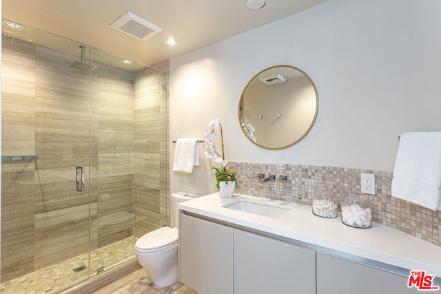 bathroom featuring walk in shower, tasteful backsplash, vanity, and toilet