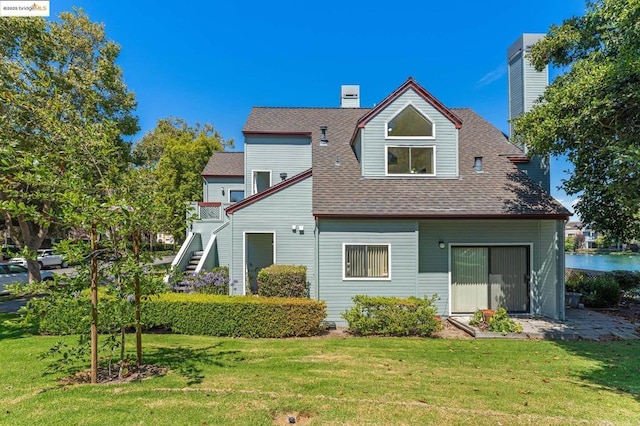 rear view of property featuring a lawn