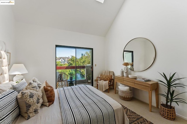 carpeted bedroom featuring high vaulted ceiling and access to outside