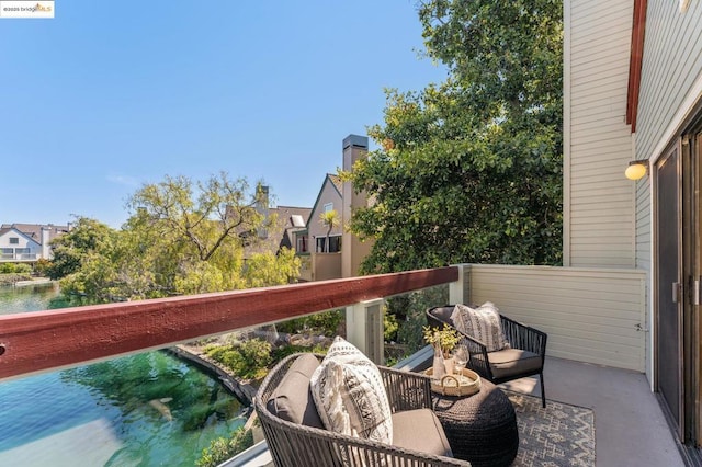 balcony featuring a water view