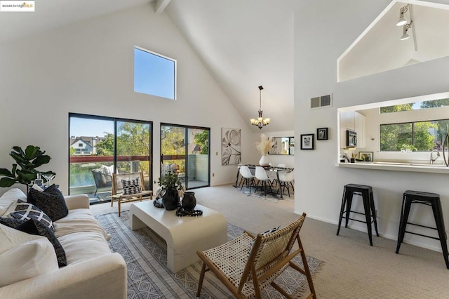 living room with beam ceiling, light carpet, and high vaulted ceiling