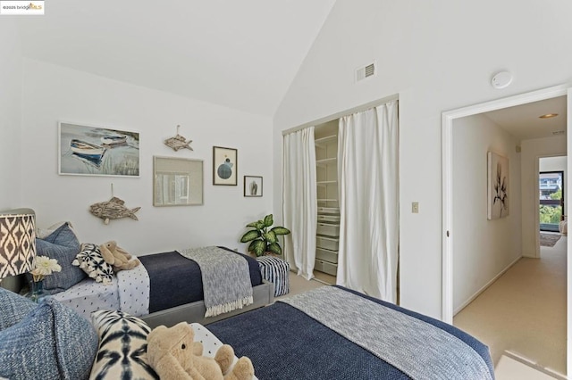 bedroom with light carpet and vaulted ceiling