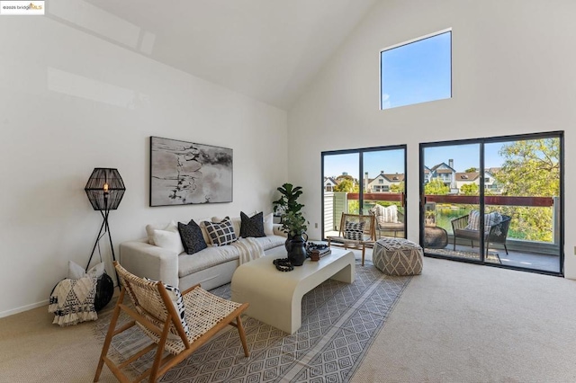 carpeted living room featuring a towering ceiling