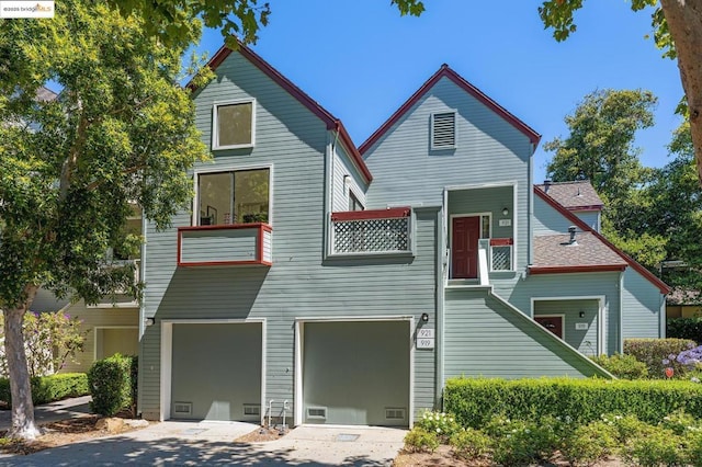 view of front of property featuring a balcony and a garage