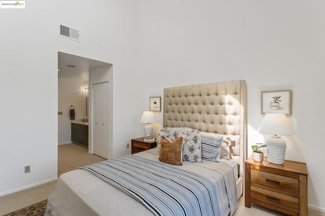 carpeted bedroom with ensuite bath