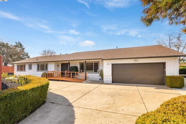 single story home with a garage and a deck