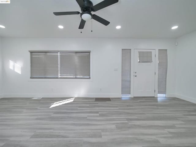 spare room featuring ceiling fan and light wood-type flooring