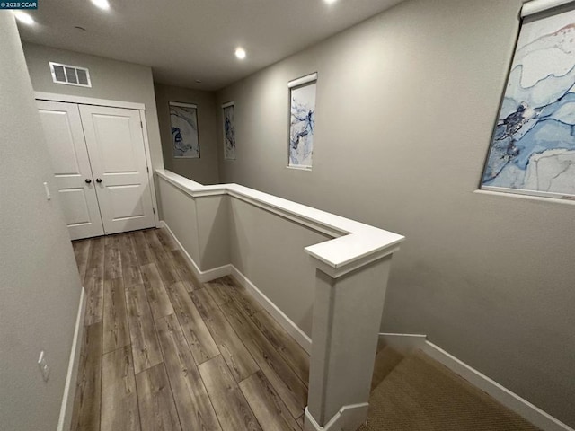 hall with hardwood / wood-style floors