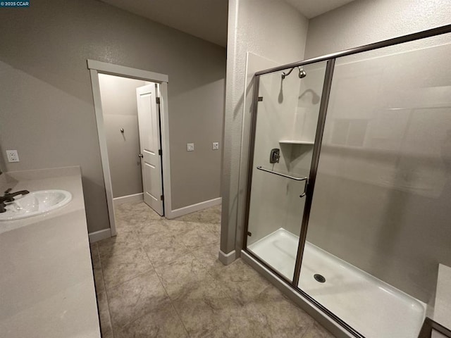 bathroom with vanity and a shower with shower door