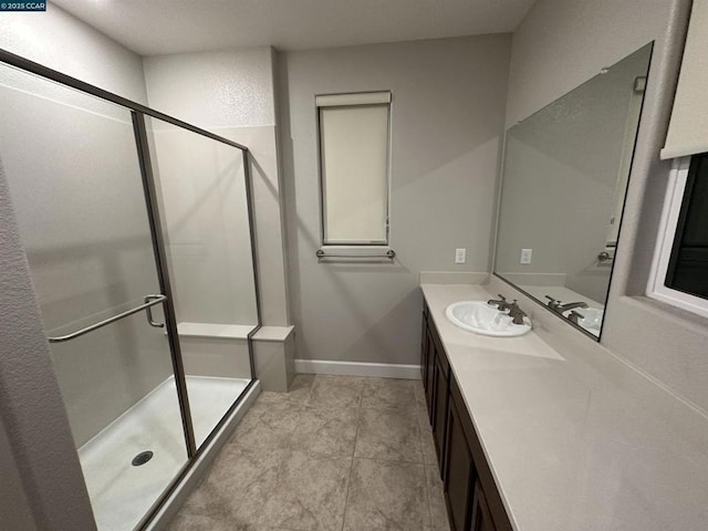 bathroom featuring vanity and a shower with shower door